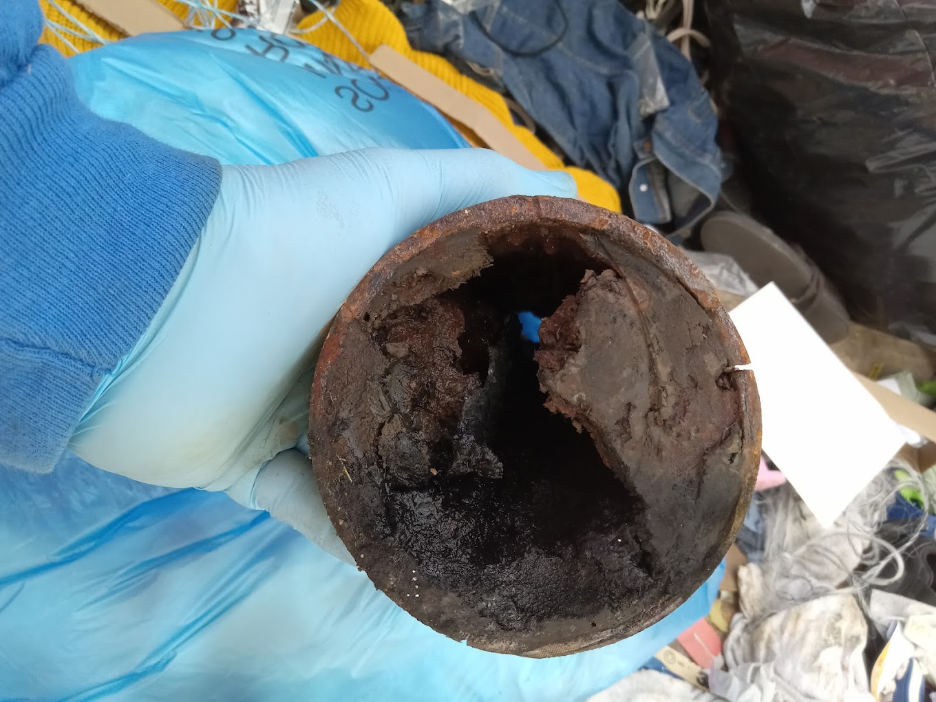 Heavily clogged drain pipe interior — reason for replacement